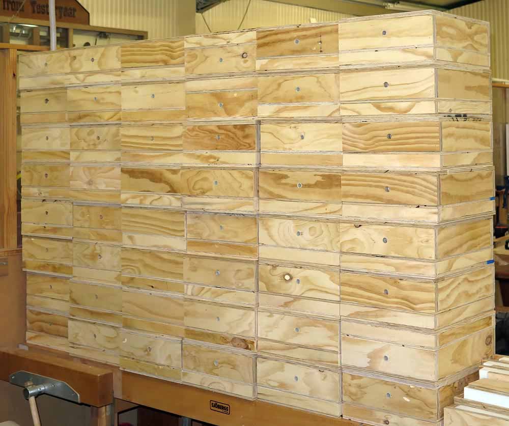 A large stack of finished native bee boxes ready for delivery