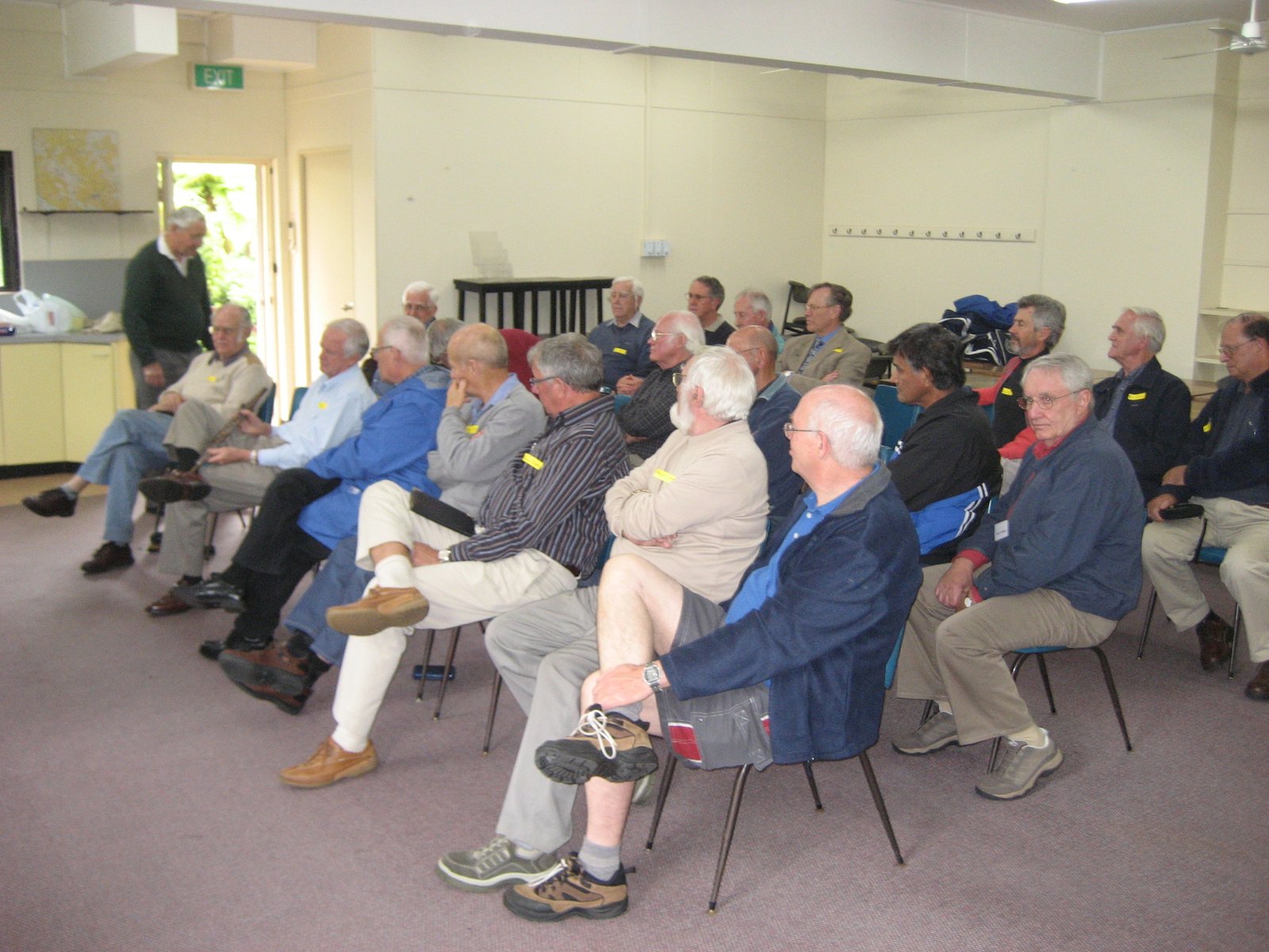 A room full of men at a Men's Shed networking meeting, many wearing name tags, 2007